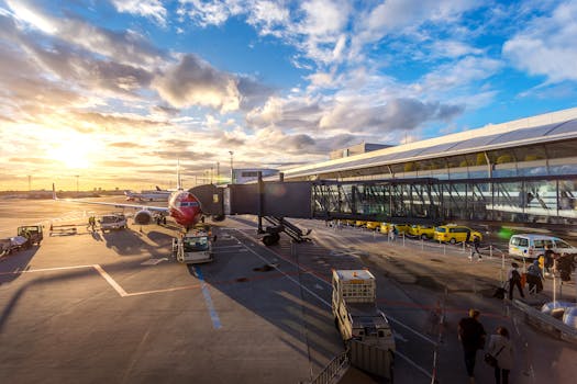 A vibrant sunset at Copenhagen Airport with airplanes and bustling activity. lazy genie, drone photography